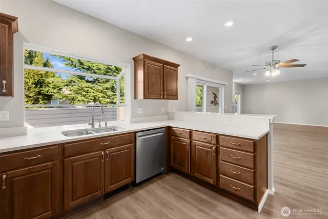 a kitchen with a sink window and cabinets