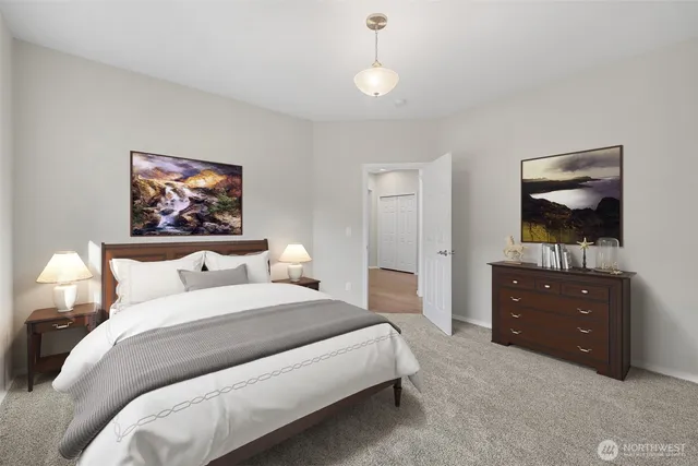 a bedroom with a bed and a flat tv screen on dresser
