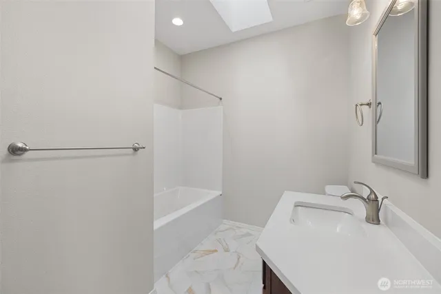 a bathroom with a sink and shower