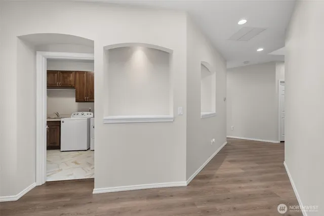 a view of a kitchen with a refrigerator and a sink