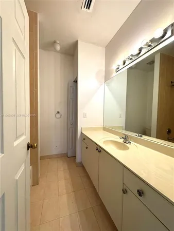 a spacious bathroom with a granite countertop sink mirror and a
