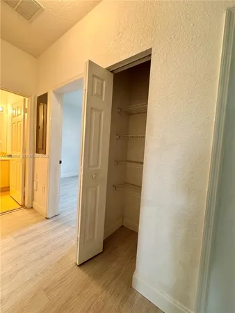 an empty room with wooden floor and a window