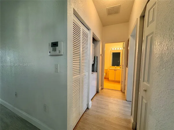 a view of a bathroom from a hallway
