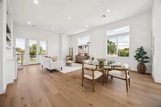 a living room with furniture and a wooden floor