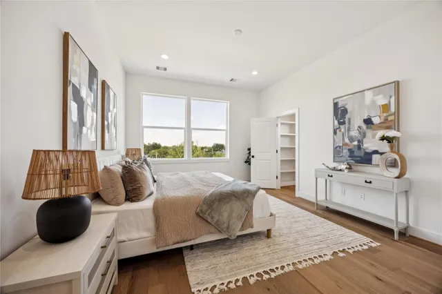 a spacious bedroom with a bed and a couch