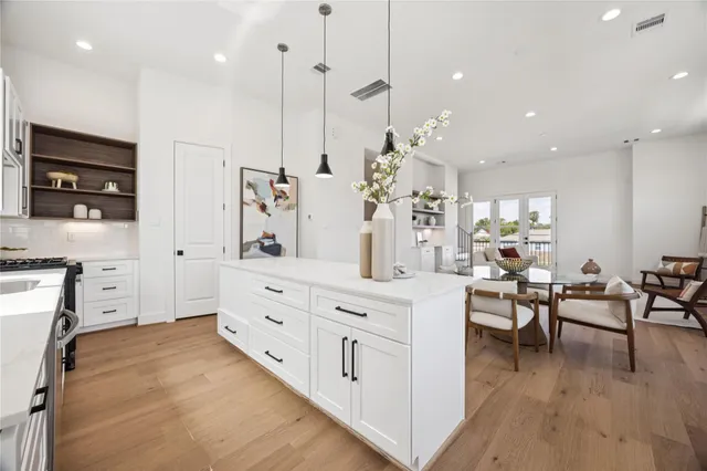 a spacious kitchen with stainless steel appliances kitchen island granite countertop a sink and cabinets