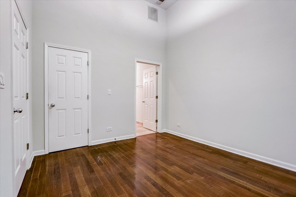 523 North Racine Avenue, Unit 1 Chicago, IL 60642 - Photo 11 of 18 a view of an empty room with wooden floor