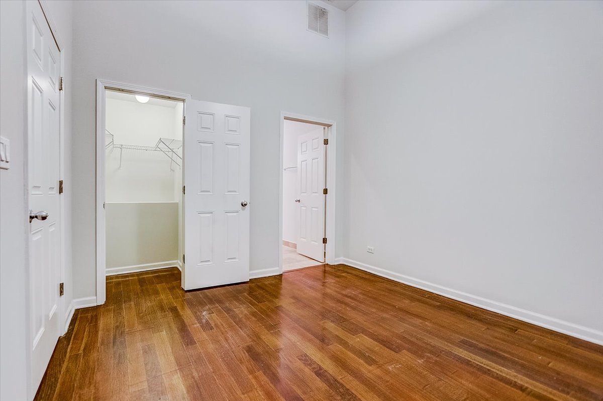 523 North Racine Avenue, Unit 1 Chicago, IL 60642 - Photo 13 of 18 a view of empty room with wooden floor