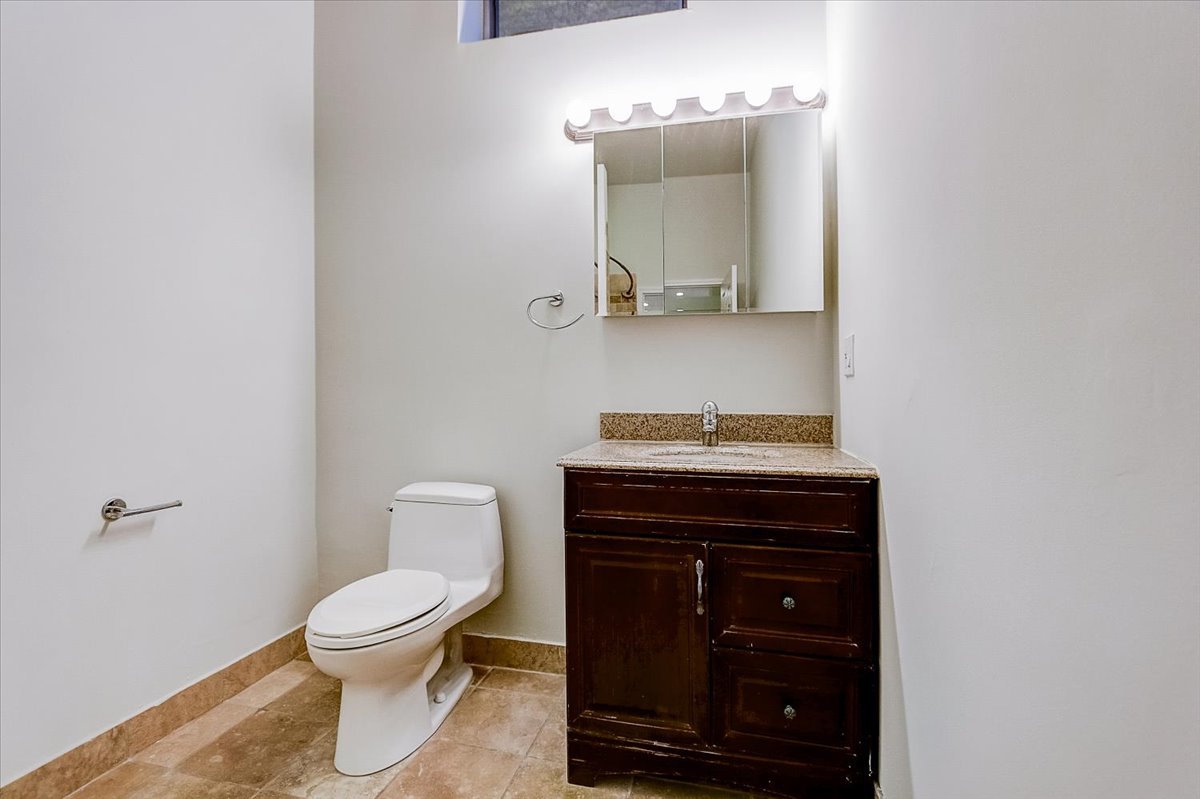 523 North Racine Avenue, Unit 1 Chicago, IL 60642 - Photo 15 of 18 a bathroom with a toilet a sink and mirror