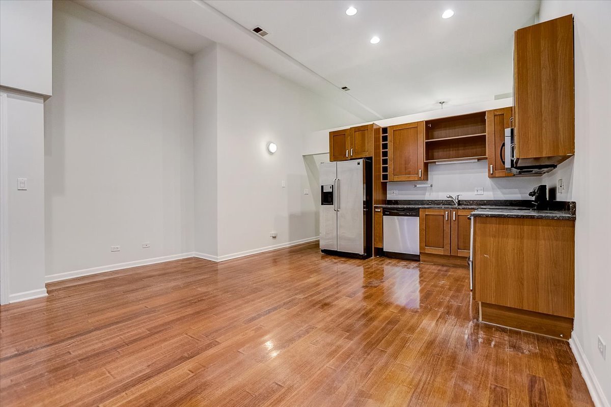 523 North Racine Avenue, Unit 1 Chicago, IL 60642 - Photo 4 of 18 a view of a kitchen with a sink and a refrigerator