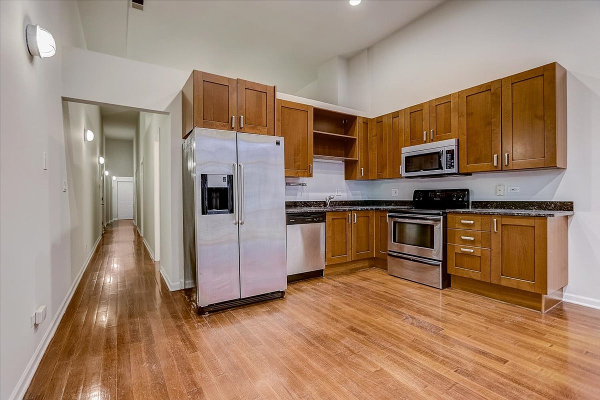 523 North Racine Avenue, Unit 1 Chicago, IL 60642 - Photo 6 of 18 a kitchen with stainless steel appliances granite countertop a refrigerator and a stove top oven