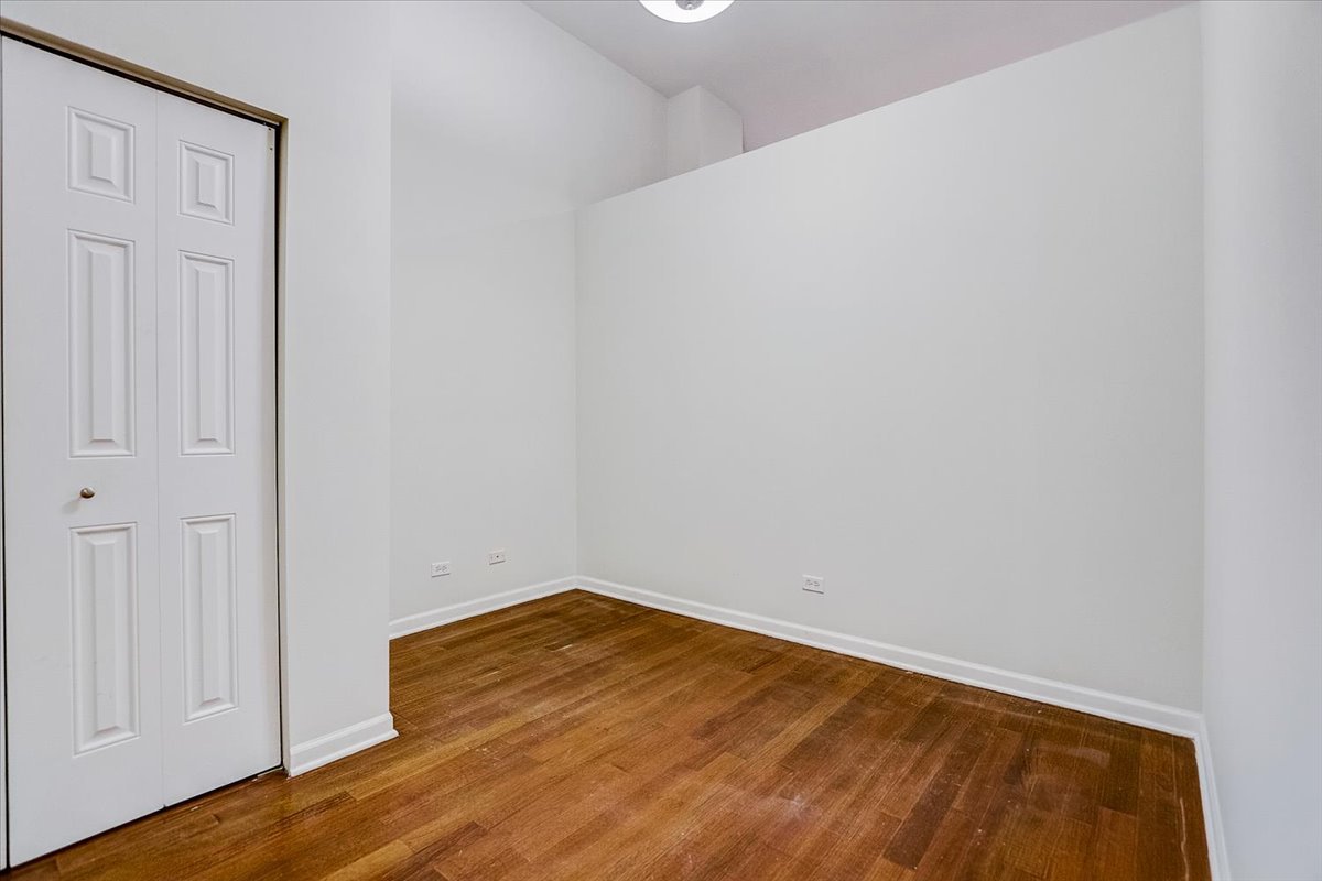 523 North Racine Avenue, Unit 1 Chicago, IL 60642 - Photo 9 of 18 a view of empty room with wooden floor