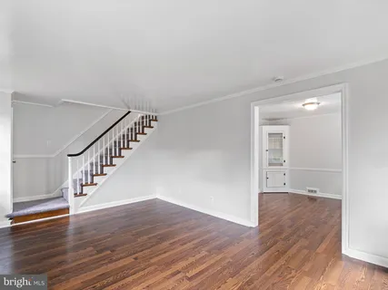 a view of an empty room with wooden floor
