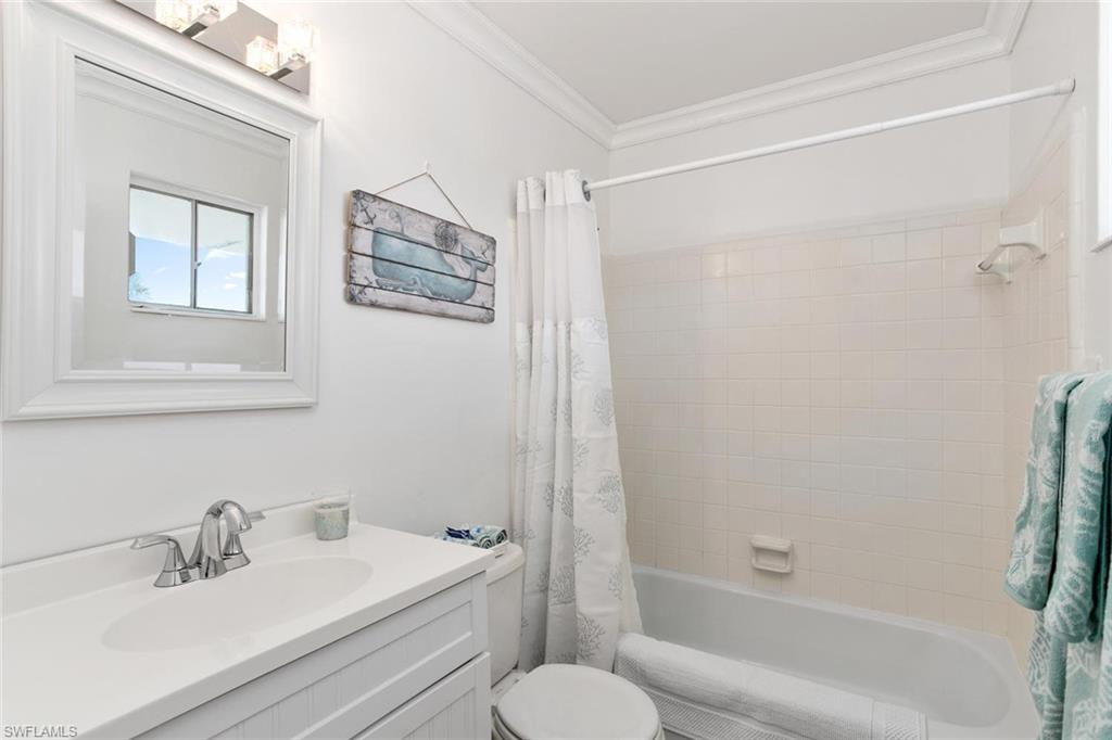 360 Capri Boulevard, Unit 201 Naples, FL 34113 - Photo 1 of 1 a bathroom with a sink toilet and shower