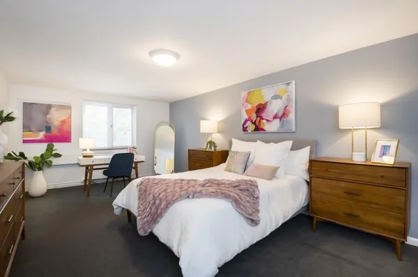 a spacious bedroom with a bed and a couch