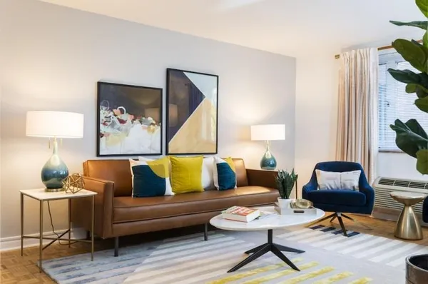 a living room with furniture and a lamp