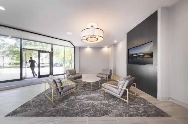 a living room with furniture and a floor to ceiling window