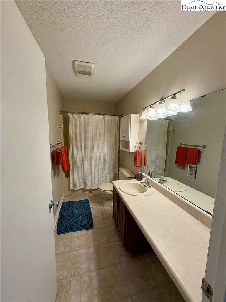5416 Bamboo Road Boone, NC 28607 - Photo 16 of 35 a bathroom with a sink vanity and a mirror