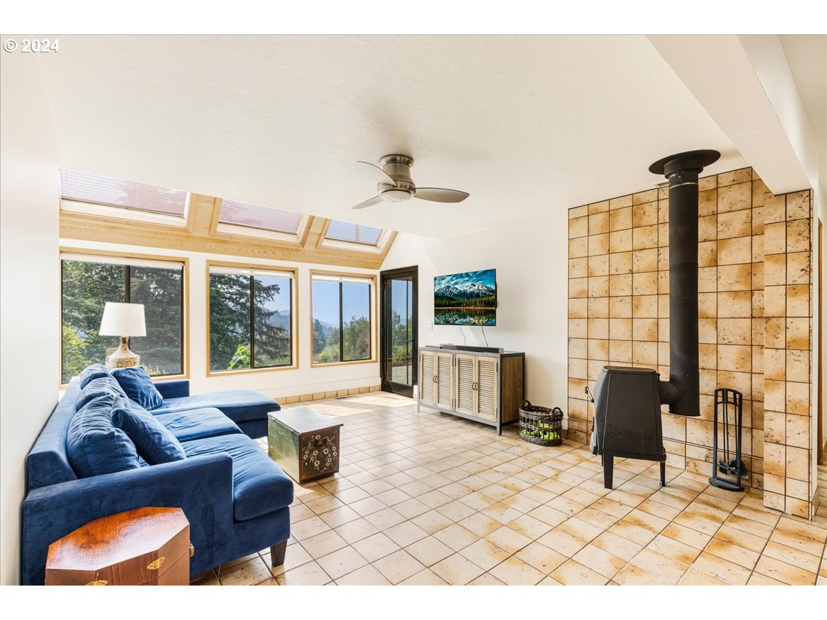 1500 Southwest Walters Drive Gresham, OR 97080 - Photo 23 of 48 a living room with furniture and a floor to ceiling window