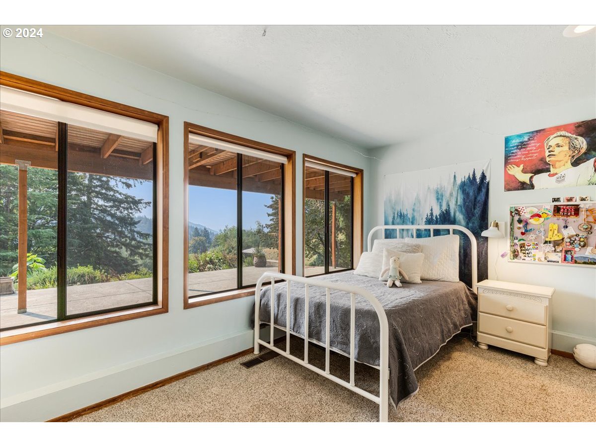 1500 Southwest Walters Drive Gresham, OR 97080 - Photo 27 of 48 a bedroom with a bed lamp and a large window