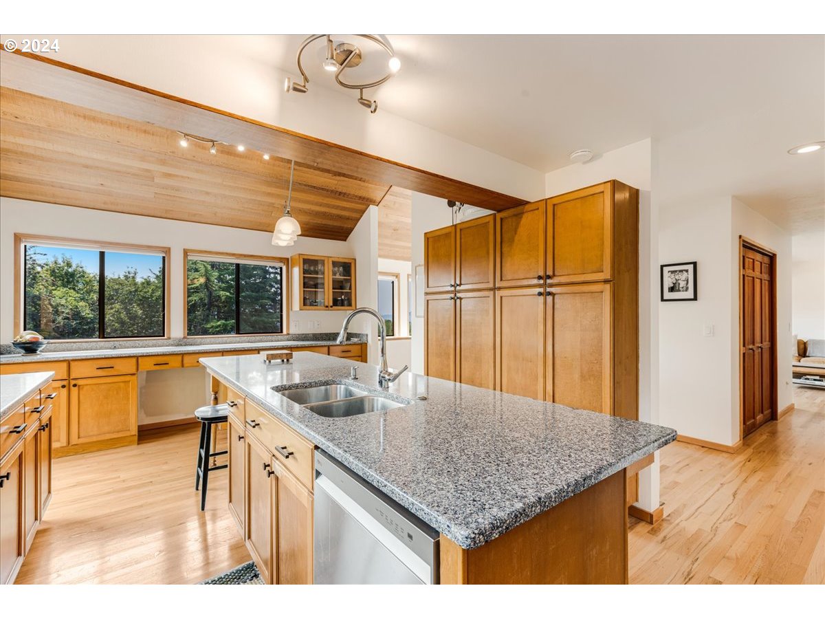 1500 Southwest Walters Drive Gresham, OR 97080 - Photo 4 of 48 a kitchen with a sink a refrigerator and wooden floor