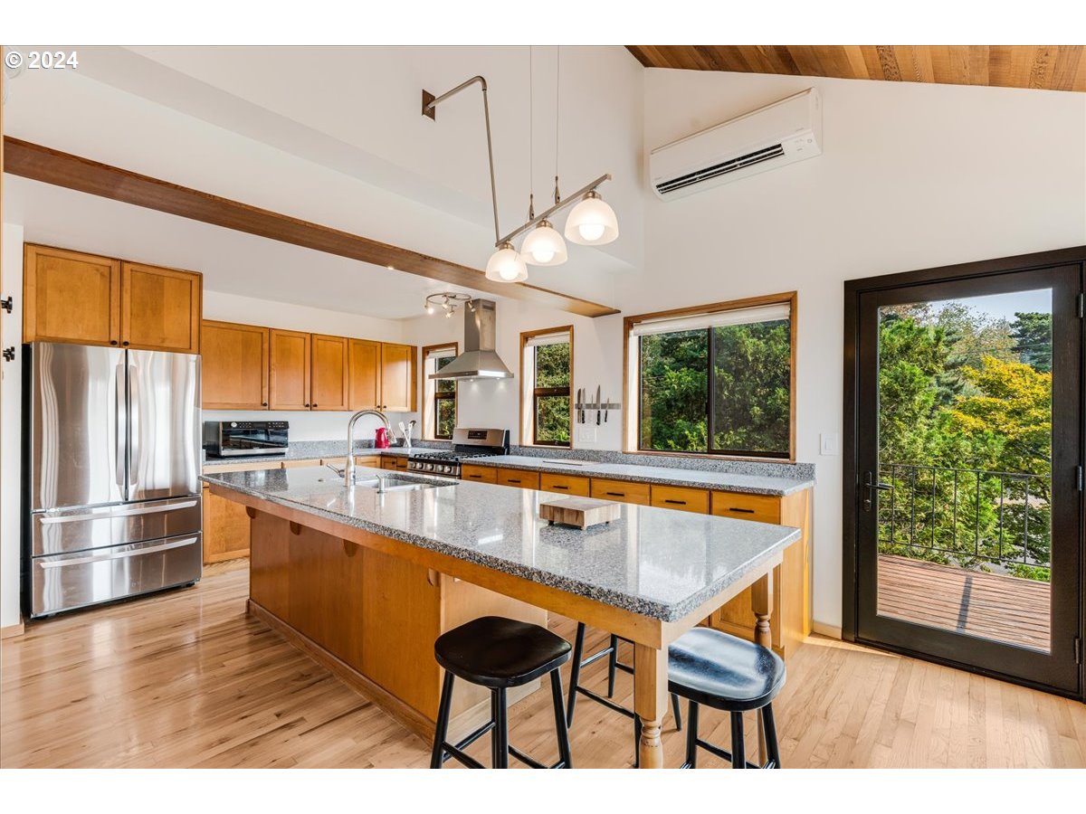 1500 Southwest Walters Drive Gresham, OR 97080 - Photo 6 of 48 a large kitchen with kitchen island a large window and stainless steel appliances