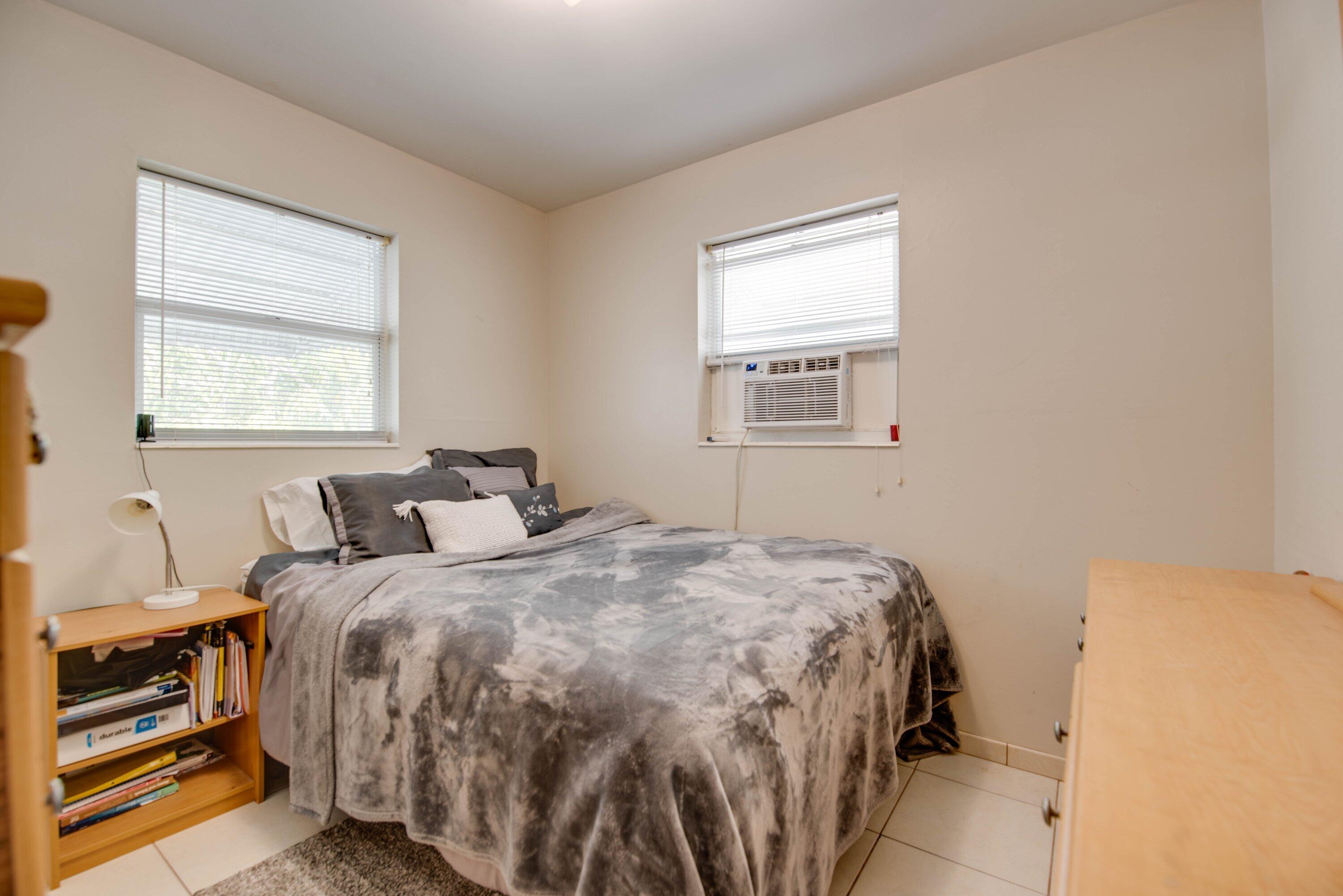 317 Cross Street Stock Island, FL 33040 - Photo 11 of 25 a bedroom with a bed and two windows