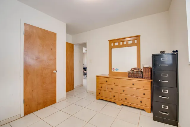 a room with a dresser and a mirror