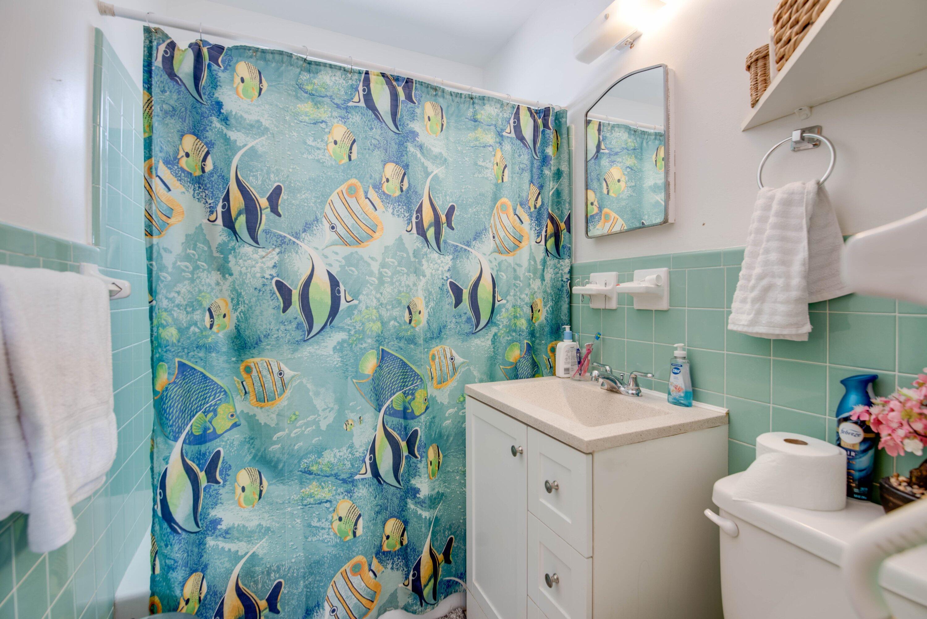 317 Cross Street Stock Island, FL 33040 - Photo 14 of 25 a bathroom with a sink and mirror with toilet