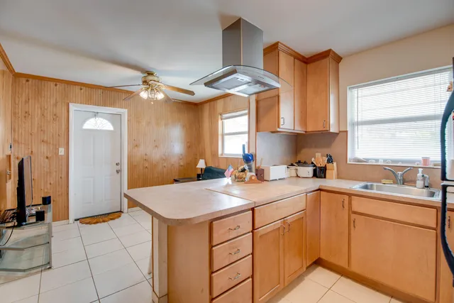 a kitchen that has a sink and a stove in it