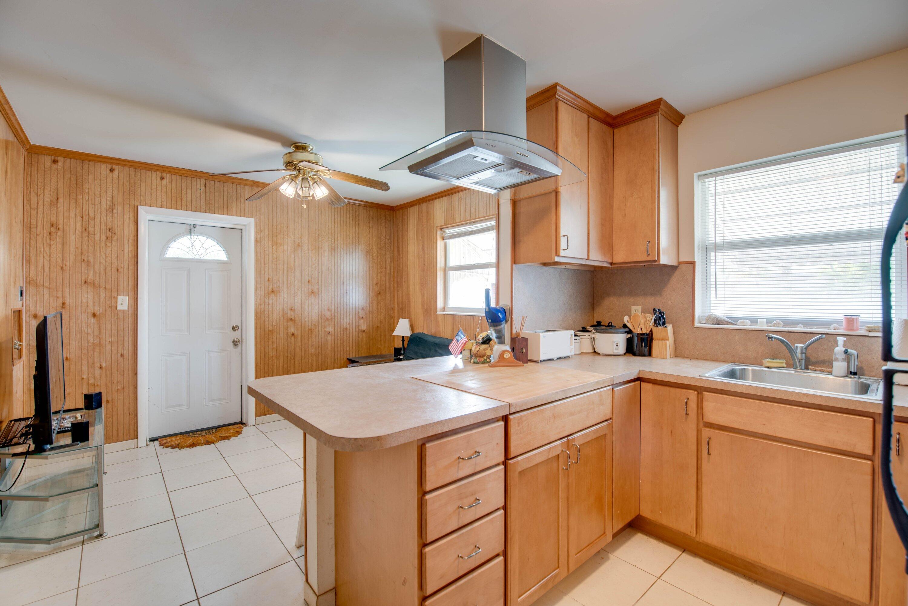 317 Cross Street Stock Island, FL 33040 - Photo 17 of 25 a kitchen that has a sink and a stove in it
