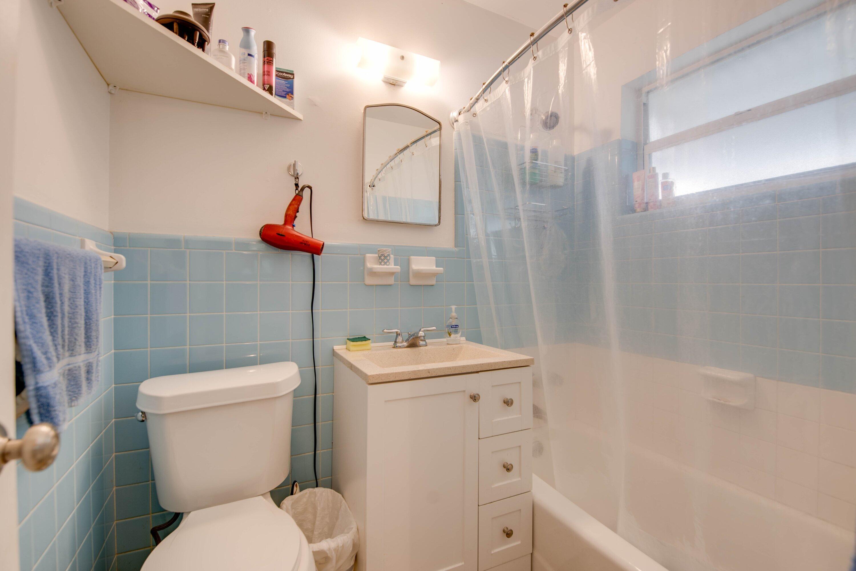 317 Cross Street Stock Island, FL 33040 - Photo 21 of 25 a bathroom with a sink a toilet and shower curtain