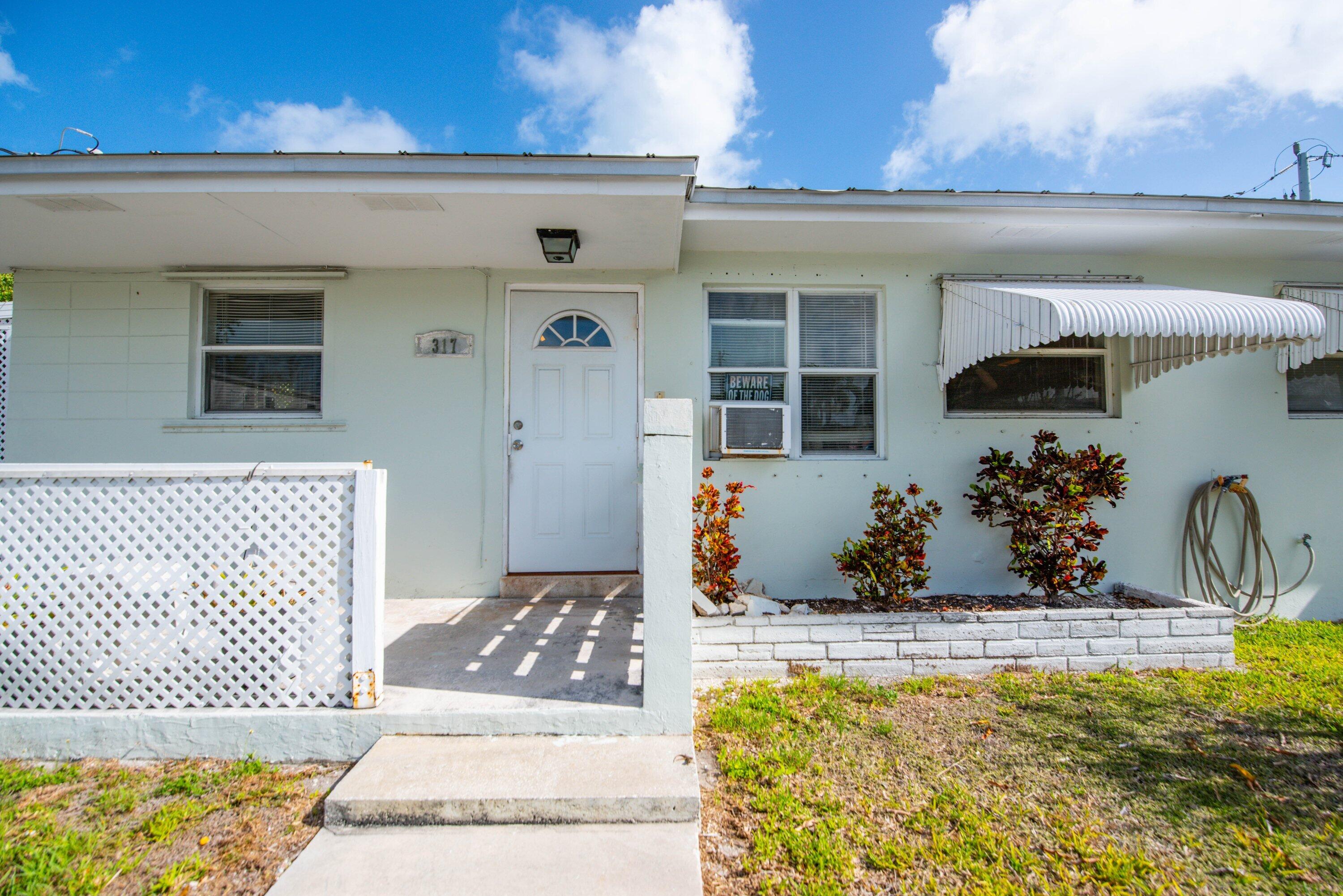 317 Cross Street Stock Island, FL 33040 - Photo 24 of 25 a front view of a house with a yard
