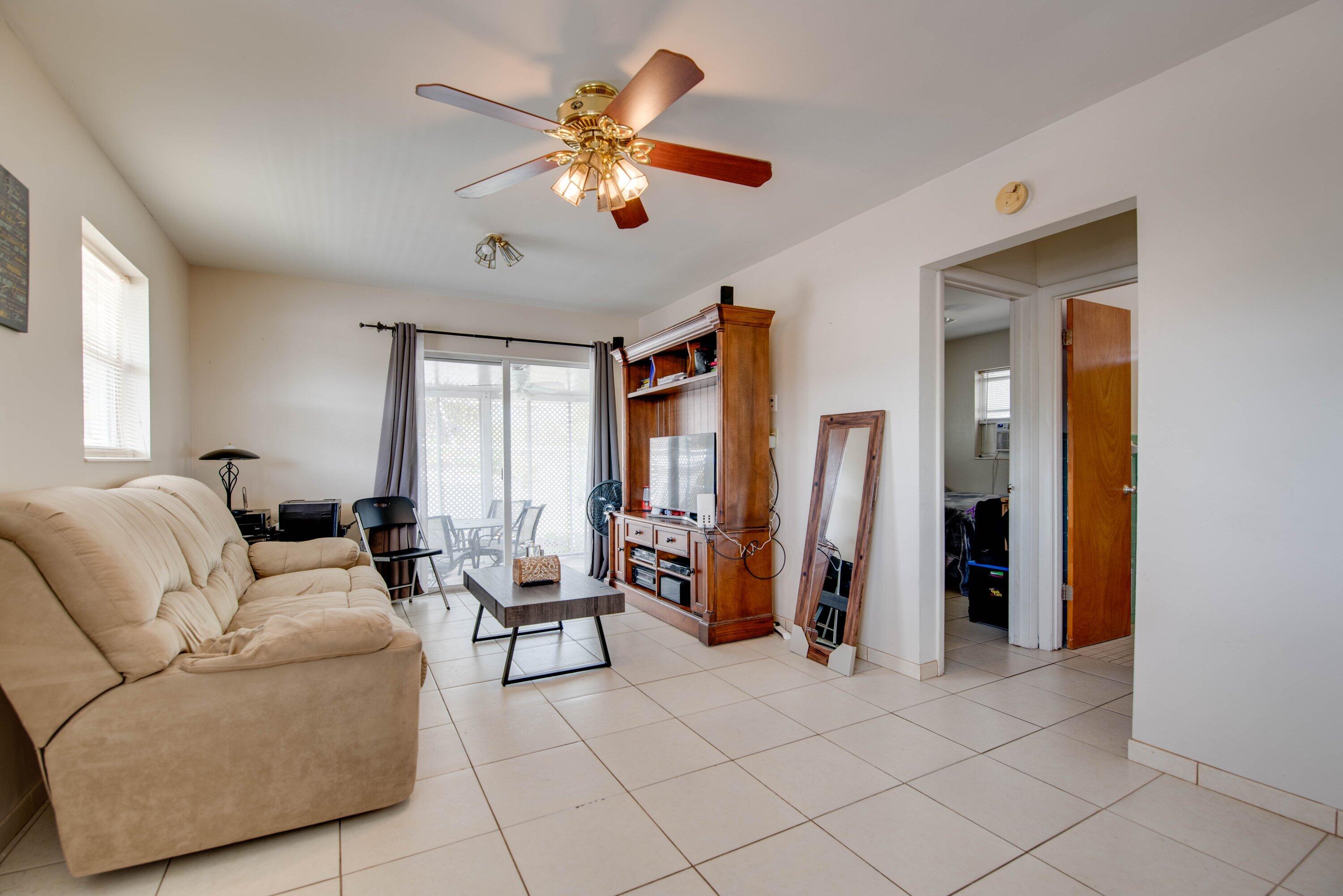 317 Cross Street Stock Island, FL 33040 - Photo 7 of 25 a living room with furniture and a chandelier
