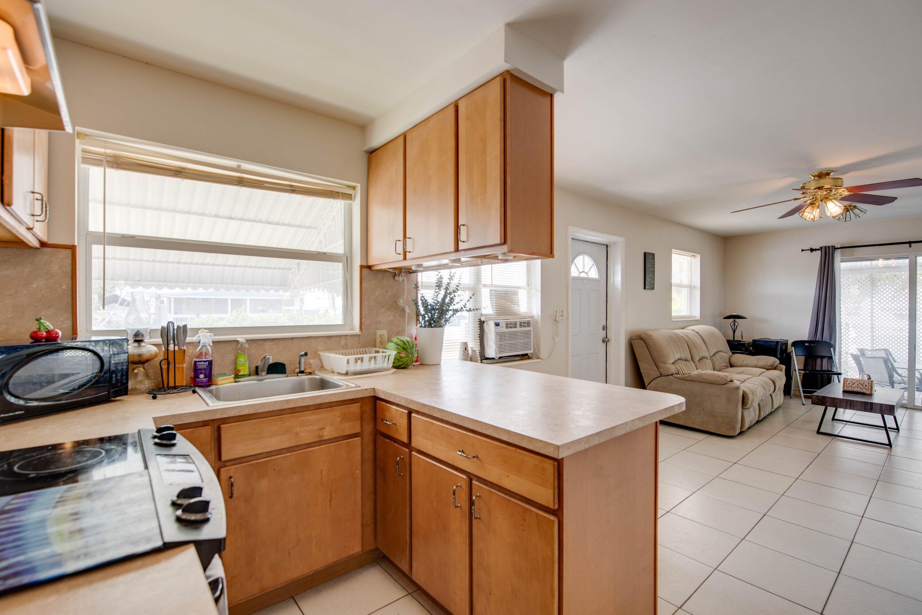 317 Cross Street Stock Island, FL 33040 - Photo 9 of 25 a kitchen that has a sink and a stove in it