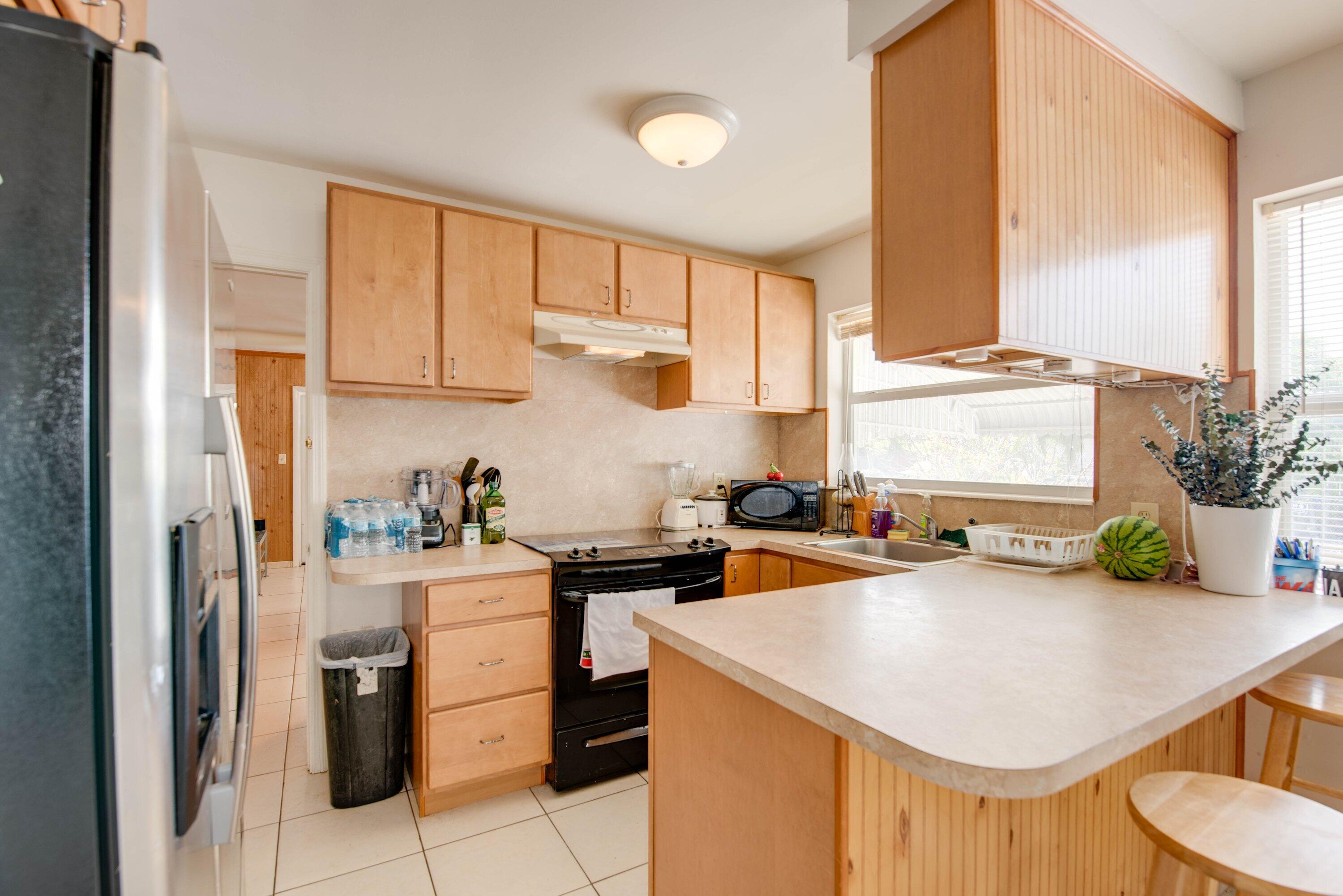 317 Cross Street Stock Island, FL 33040 - Photo 10 of 25 a kitchen with stainless steel appliances a sink a counter top space and living room view