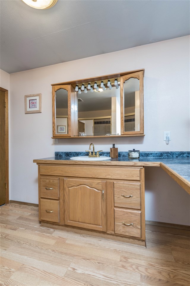 1098 Drexel Road Lake Summerset, IL 61019 - Photo 17 of 25 a spacious bathroom with a granite countertop sink and a mirror