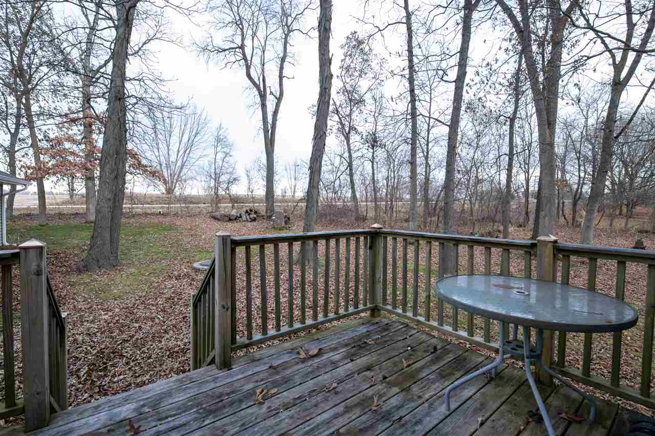 1098 Drexel Road Lake Summerset, IL 61019 - Photo 4 of 25 a view of a wooden deck with furniture and trees