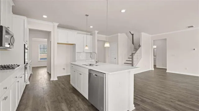 a kitchen with a stove oven and a sink