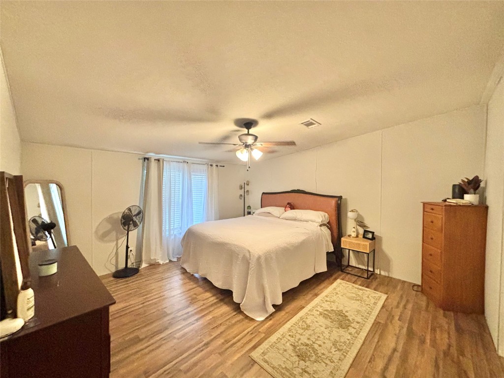 1580 Farm To Market 1745 Colmesneil, TX 75938 - Photo 14 of 36 a bedroom with a bed and wooden floor