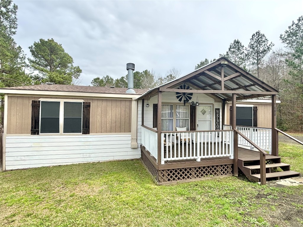 1580 Farm To Market 1745 Colmesneil, TX 75938 - Photo 4 of 36 a view of a house with a wooden deck and a yard