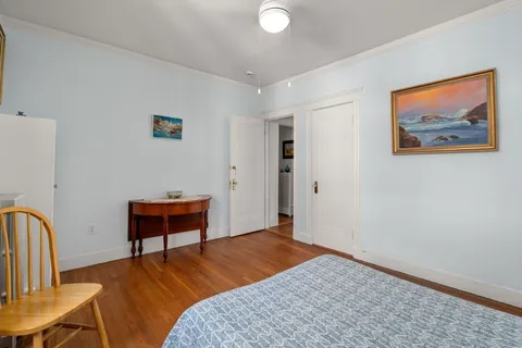 a bedroom with a bed and a dresser