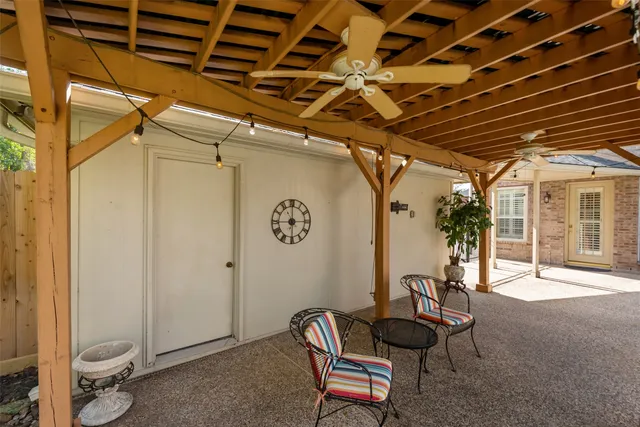 a view of a patio with a table chairs and a backyard