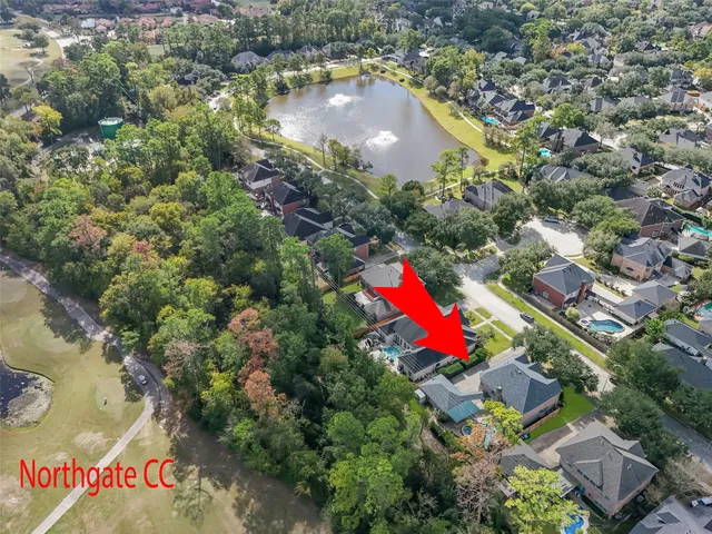 an aerial view of residential houses with outdoor space and street view