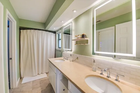 a bathroom with a double vanity sink and a mirror