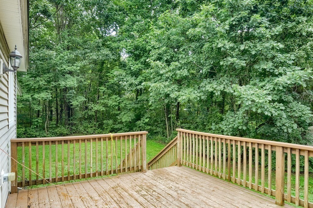 9 Meadowbrook Circle Rutland, MA 01543 - Photo 6 of 27 a balcony with wooden floor and trees in the background