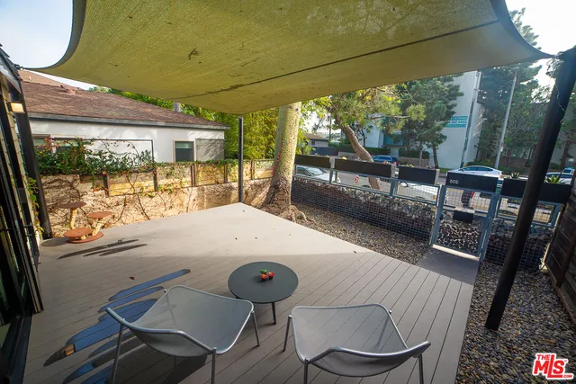 a view of a patio with a table chairs and a backyard