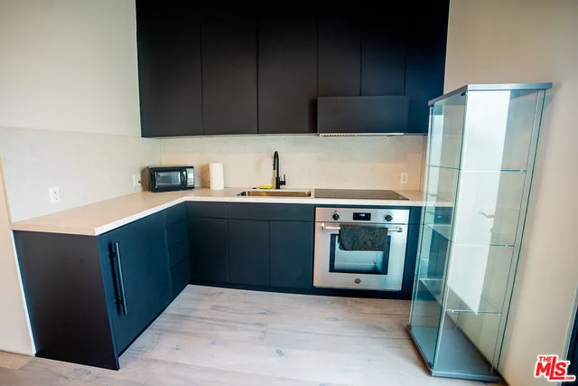 a kitchen with a sink and a refrigerator