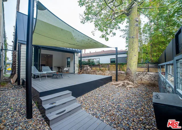 a view of a backyard with sitting area