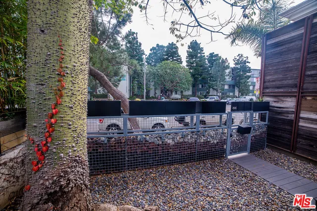 a view of balcony with wooden fence and trees
